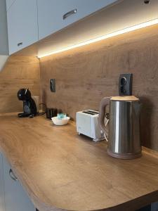 a counter top with a coffee pot and a toaster at Cozy studio near the park with huge verandah. in Veliko Tŭrnovo