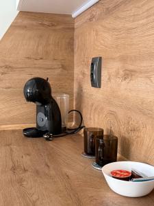 a mixer sitting on a counter with a bowl of sauce at Cozy studio near the park with huge verandah. in Veliko Tŭrnovo +12 photos