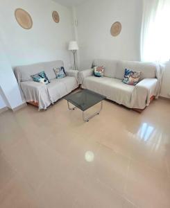 a living room with two couches and a coffee table at Brisa MarinaTerraza Vistas a la Isla Free Parking in Carboneras