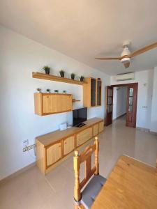 a large kitchen with wooden cabinets and a table at Brisa MarinaTerraza Vistas a la Isla Free Parking in Carboneras