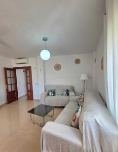 a living room with a couch and a table at Brisa MarinaTerraza Vistas a la Isla Free Parking in Carboneras