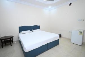 a bedroom with a large bed and a small table at بيت سلسبيل in Al Madinah