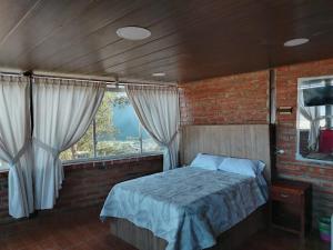 Ένα ή περισσότερα κρεβάτια σε δωμάτιο στο Hospedaje Mágico Arcángel