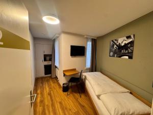 a hospital room with a bed and a desk at Hotel R5 Budget - Chur in Chur