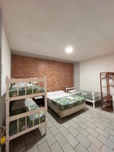 Ένα ή περισσότερα κρεβάτια σε δωμάτιο στο BC Paradise Hostel & Suítes