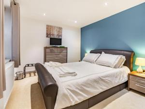 a bedroom with a large bed and a television at Cobble Cottage - Uk38973 in Whitby +17 photos