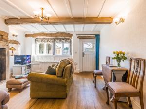 a living room with a couch and a table at Lodge Farm Cottage in Haworth