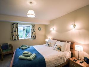 En eller flere senge i et værelse på The Corn House - Cottage