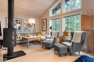 a living room with chairs and a fireplace at Fagerasen 303 by Vacation Trysil in Mælem