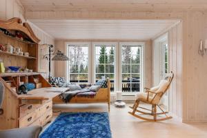 a living room with a large window and a couch at Fagerasen 303 by Vacation Trysil in Mælem