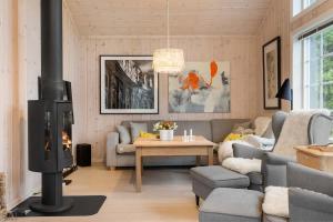 a living room with a couch and a fireplace at Fagerasen 303 by Vacation Trysil in Trysil