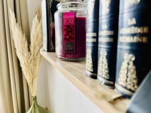 a shelf with books and a jar on it at Le Clos du Green in Levernois