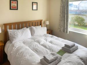 a bedroom with a bed with towels on it at 1 Lonsdale House in Keswick