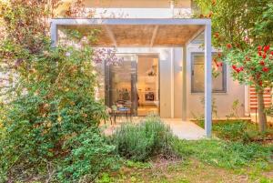 a house with a glass door leading to a patio at Central cozy garden flat in Mesochórion +10 photos