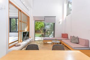 a living room with a couch and a table at Central cozy garden flat in Mesochórion