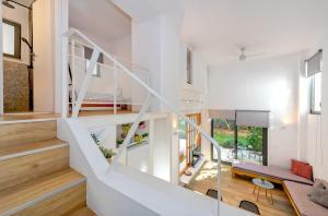 a staircase in a home with white walls and wood floors at Central cozy garden flat in Mesochórion