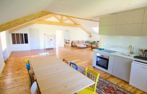 a kitchen and dining room with a wooden table at Gite NAYA in Saint-Christophe-sur-Dolaison
