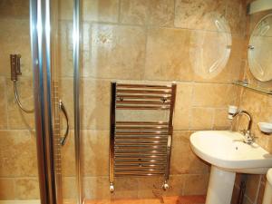 a bathroom with a shower and a sink at Gill Barn in Bampton