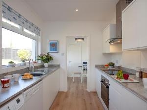 a kitchen with a sink and a counter top at Blue Horizon in Sidmouth +23 photos