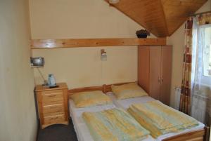 a small bedroom with a bed and a dresser at Willa pod Pilskiem in Korbielów +27 photos