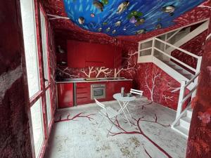 a kitchen with a ceiling with a fish painting on it at Paciu Maison in Ozzano dell Emilia +1 photo