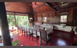 a dining room with a long table and chairs at Rice Village Home Stay in Alleppey