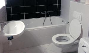 a bathroom with a white toilet and a sink at Mo Apartman in Budapest