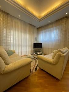 a living room with two couches and a television at A Casa di Ale in Gubbio