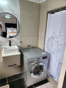 a washing machine in a bathroom with a sink at WinHaven Guest House in Randfontein +153 photos