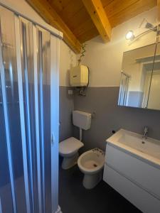 a bathroom with a toilet and a sink and a mirror at Casa Ida in Sestri Levante +15 photos