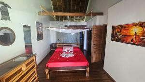 a room with a red bed in a room at La Vie Est Belle in Ambaro +22 photos