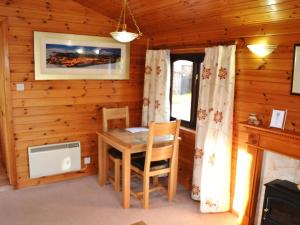 a dining room with a table and chairs in a cabin at Ashness in Keswick