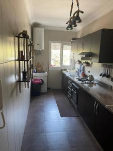 a kitchen with a sink and a stove top oven at Confort & Emplacement, Pieds dans l'eau in Mansouria +5 photos