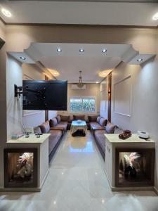 a large living room with a couch and a tv at Confort & Emplacement, Pieds dans l'eau in Mansouria