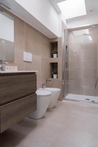 a bathroom with a toilet and a sink and a shower at Hotel Philadelphia in Cattolica