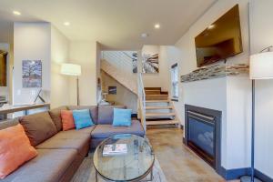 a living room with a couch and a fireplace at Urban Roundabout in Bend