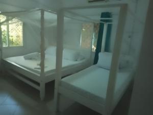 Postel nebo postele na pokoji v ubytování Garner house watamu + 11 fotografií