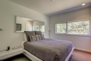 a bedroom with a bed and a large mirror at Neal Creek Retreat in Mount Hood