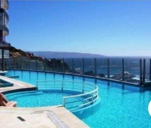 a large swimming pool on top of a building at Pingel Apartment Vista Mar in Viña del Mar +10 photos