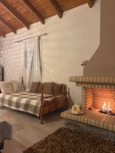 a bedroom with a bed and a fireplace at Ανέμη in Panayía