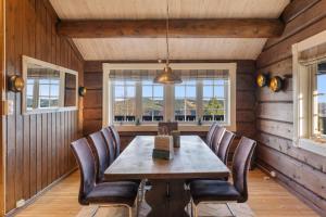 a dining room with a wooden table and chairs at Trysilfjell 615 by Vacation Trysil in Hovi