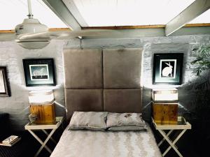 a bedroom with a bed and two lamps on tables at Soul Oasis Urban Retreat in Centurion