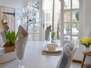 a white dining room with a table and chairs at Toad Hall in Helmsley