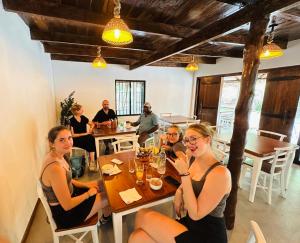 a group of women sitting at a table in a restaurant at Pepper Hills Hostel & Cottages in Ella +65 photos