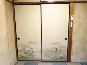 a sliding glass door with a painting on it at 豊橋南栄駅徒歩1分 最大9名一棟貸 ホタルヤ Guest House Hotaruya Toyohashi Minami Sakae in Toyohashi