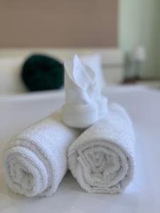 a stack of towels sitting on a bathroom sink at AnhHouse85 Da Nang - 750 meters from the beach - Free airport pick up and free modern coffee machine provided in Da Nang