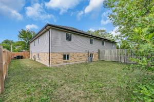 a house with a fence in a yard at Bright and chic home with a cozy touch in Windsor