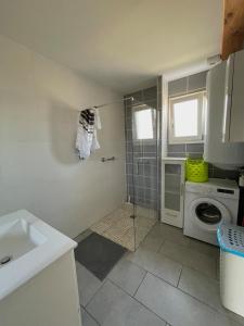 a bathroom with a shower and a washing machine at Au petit Suquet in Andregeat +14 photos