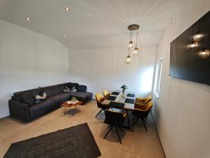 a living room with a couch and a table at HausTipTop in Flachau
