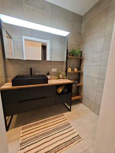 a bathroom with a black sink and a mirror at HausTipTop in Flachau +41 photos